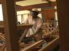 Man from Burma building a loom