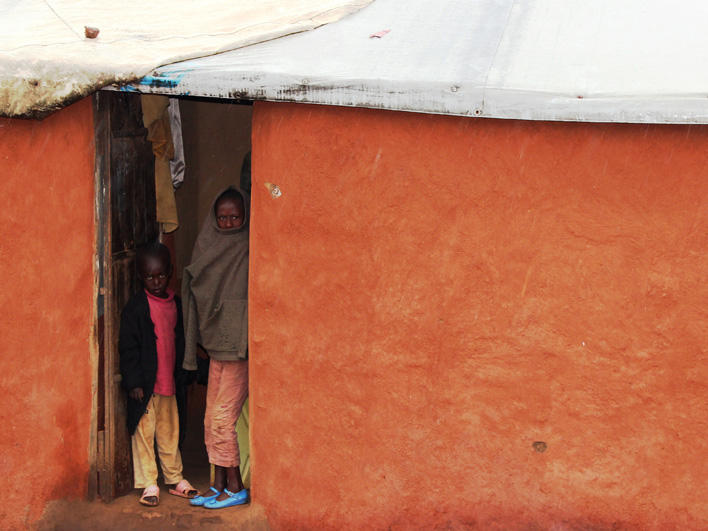 Congolese in doorway in Gihembe camp in Rwanda