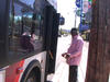 A senior refugee preparing to board a bus